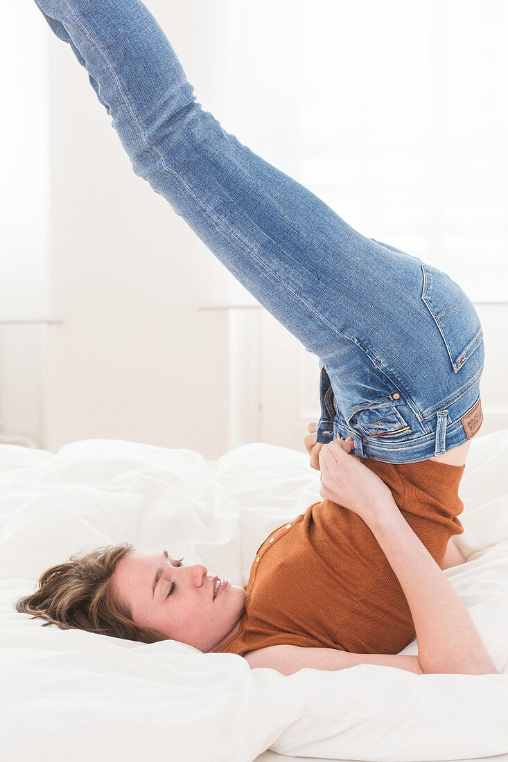 Woman putting on jeans