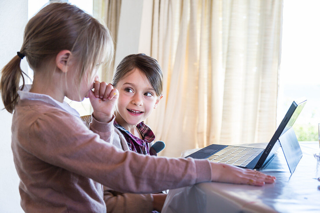 Sisters using laptop