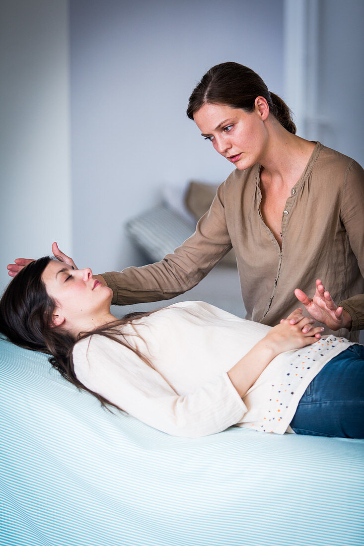 Woman receiving Reiki treatment