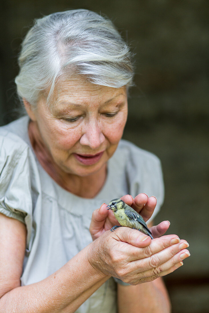 Woman caressing a bird