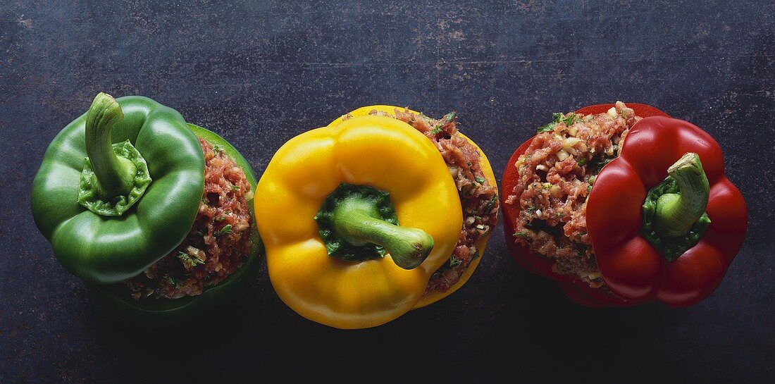 Three raw peppers stuffed with mince