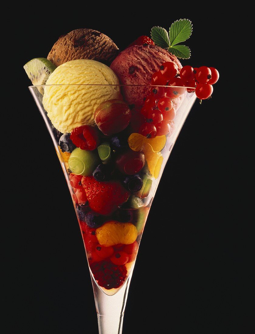 Fruit Salad topped with Three Ice Cream Scoops in a Stem Glass
