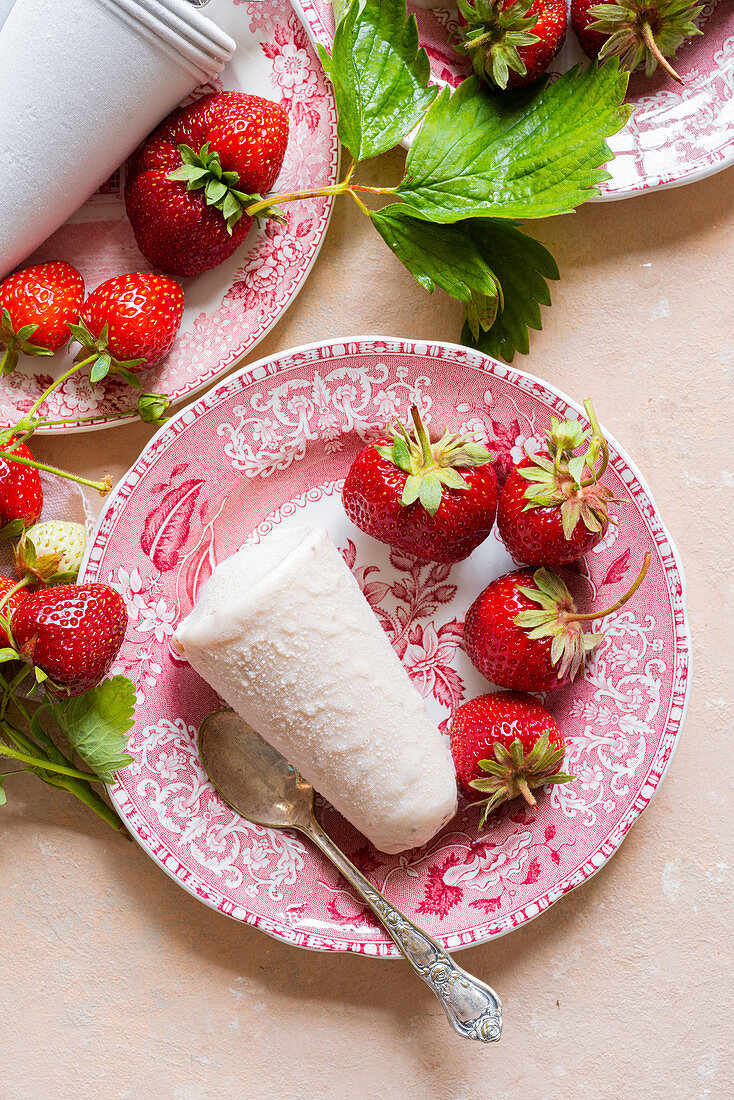 Strawberry Kulfi served on pink china plates, pink linen with fresh picked strawberries