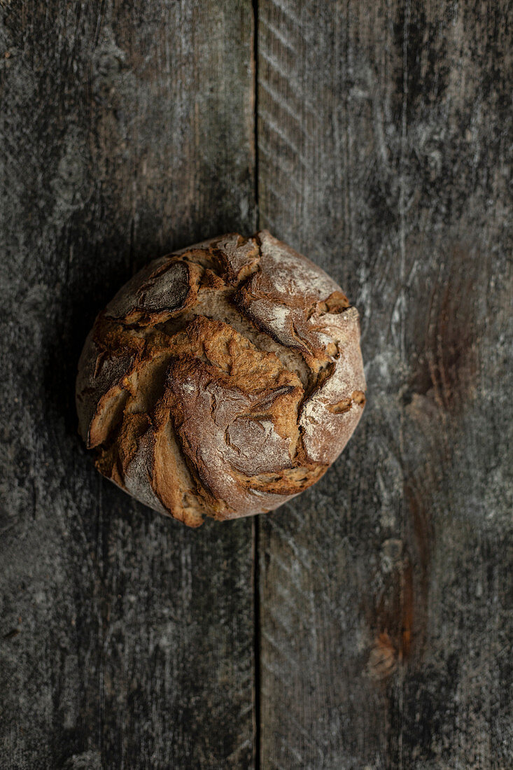Loaf of bread on wooden background