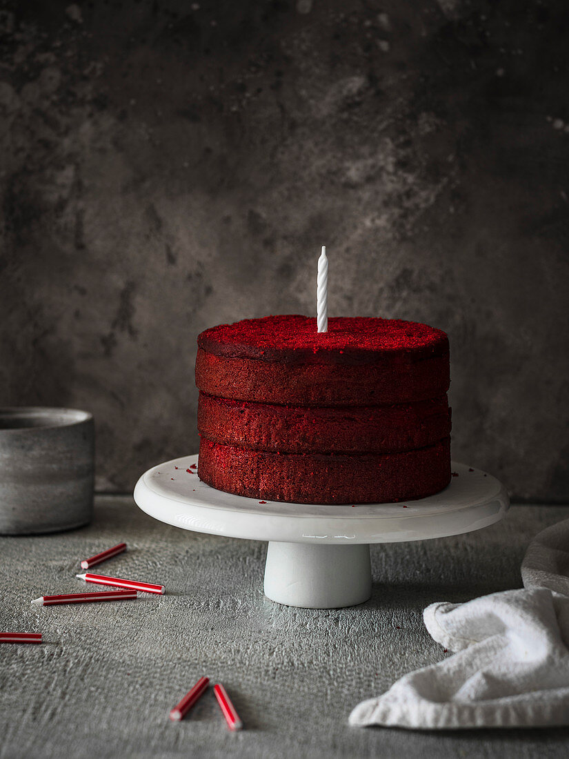 red velvet naked cake with candles on the table