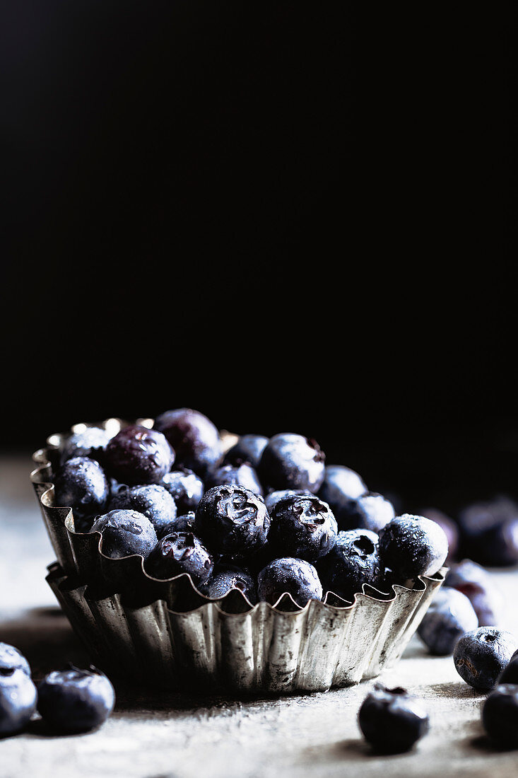 Dark shot of organic blueberries with negative space