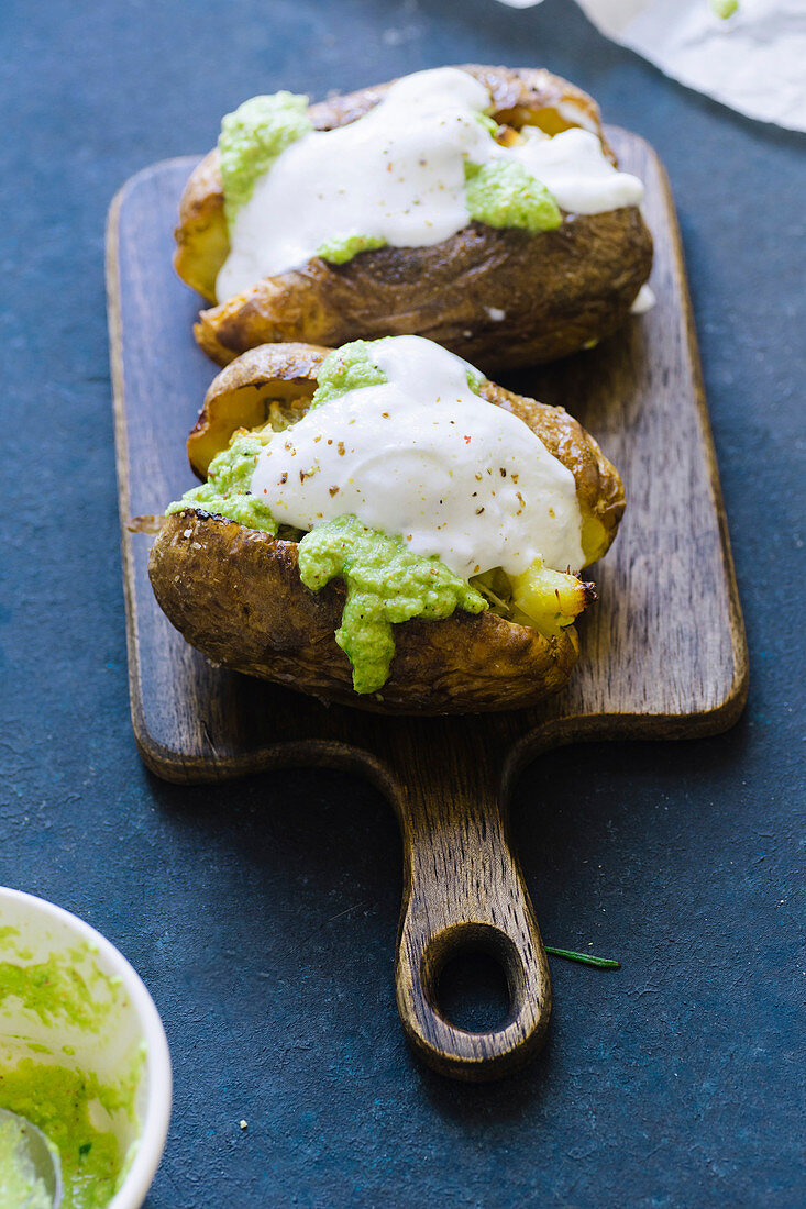 Twice baked potatoes with scallions, garlic and olive oil served with green pesto sauce