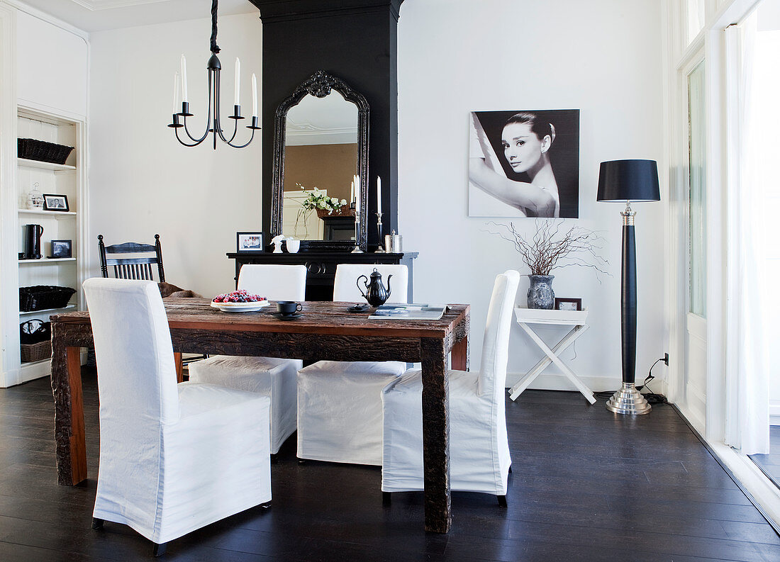 Rustic wooden table with cover chairs in front of the fireplace in the dining room