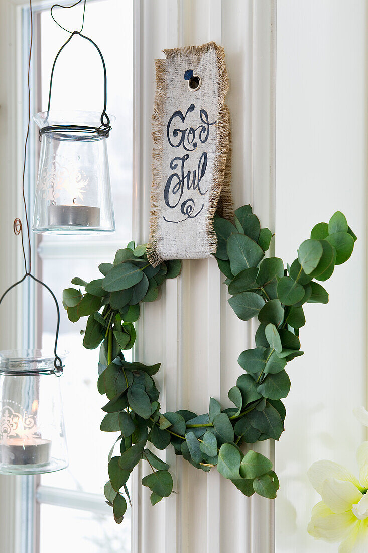 DIY wreath from eucalyptus branches hung from a piece of ribbon