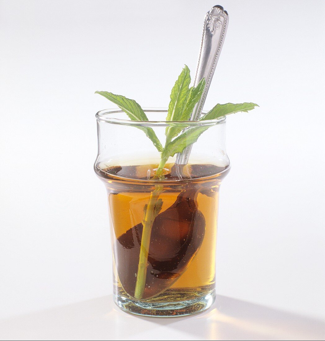 A glass of peppermint tea with fresh mint