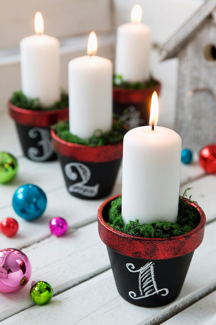 Black chalkboard painted flower pots with candles as an alternative Advent wreath