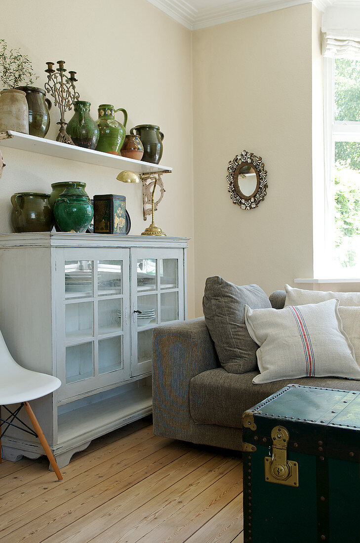 Collection of old clay jugs in green in the living room