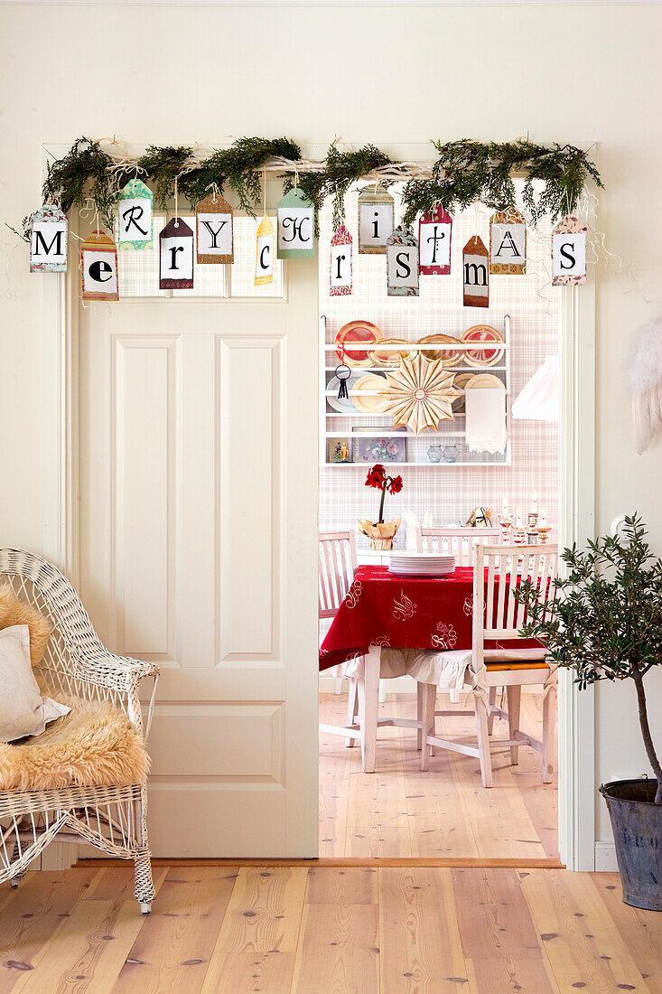DIY garland with Christmas greeting above the room door