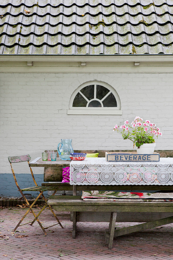 Rustic table with a lace ceiling on the terrace