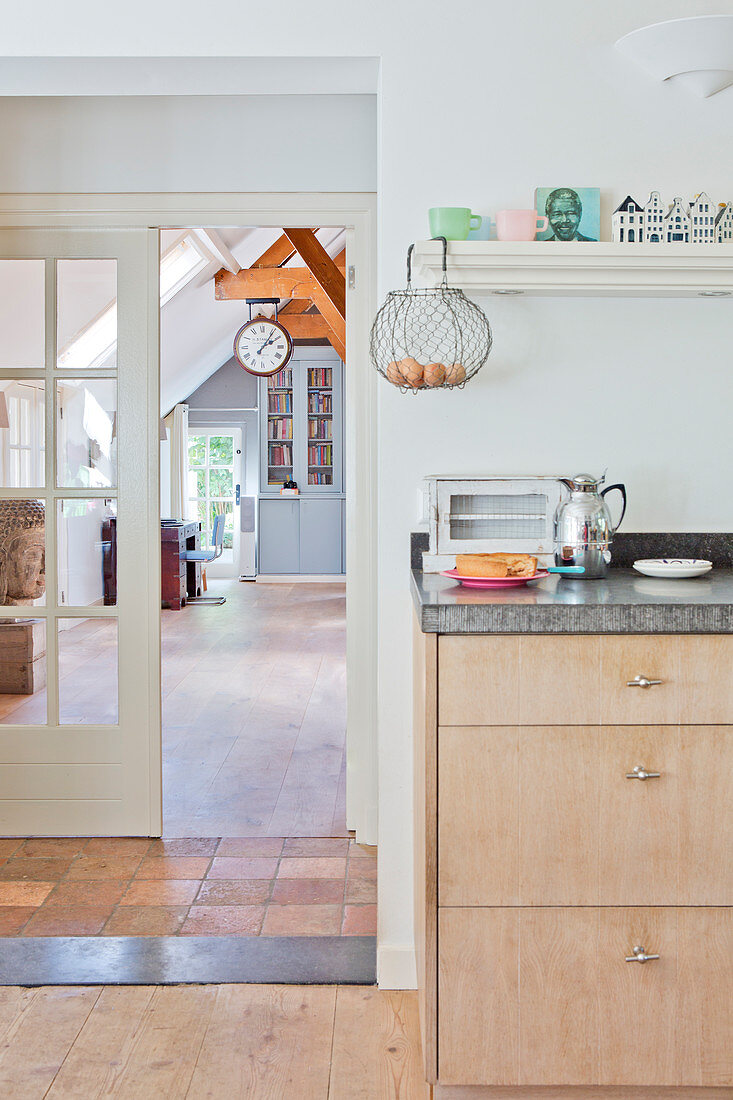 Kitchenette, above it an egg basket on the shelf next to the passage