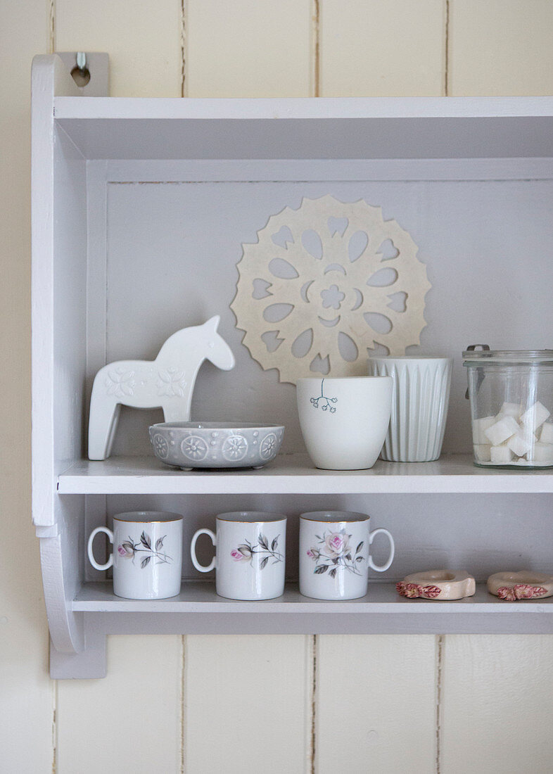 Swedish Dala horse and nostalgic dishes on an old wall shelf