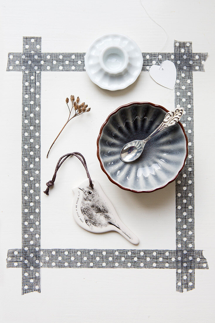 Bowl, bird pendant, and egg cup in a frame made of gray washi tape
