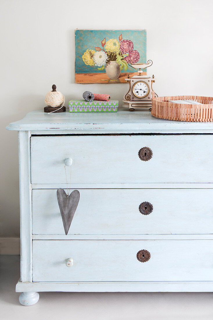 Vintage accessories on old pale blue chest of drawers