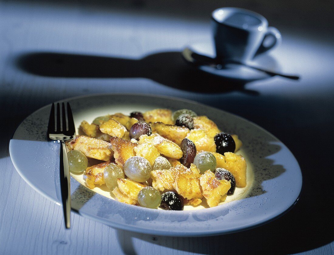 Browned Pancake (Kaiserschmarren) with Grapes and Powdered Sugar