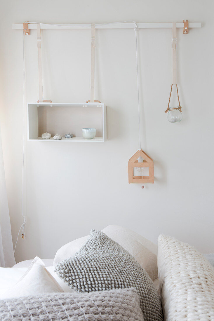 Rod on the wall with a hung box as a shelf and decoration