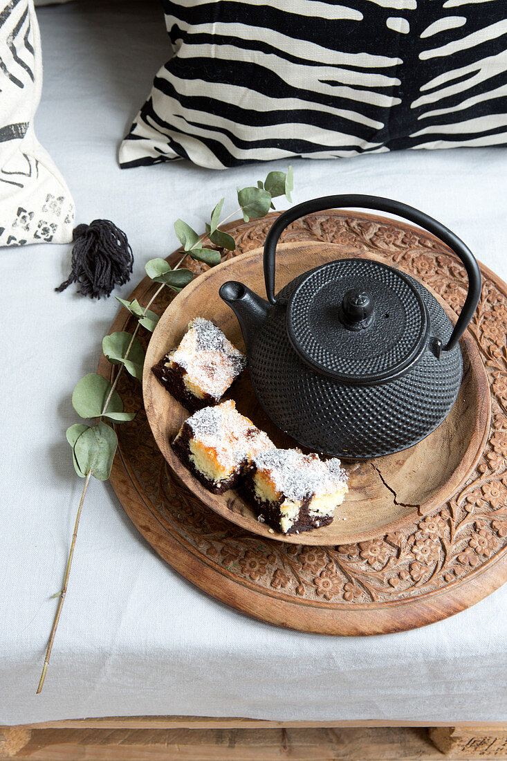 Marble cake on the tray next to an Asian teapot