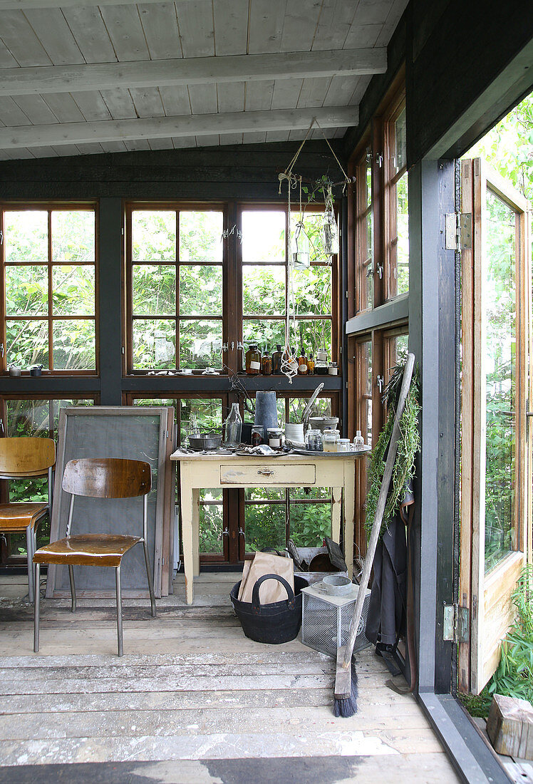 Old school chairs and a drawer table in a glass house