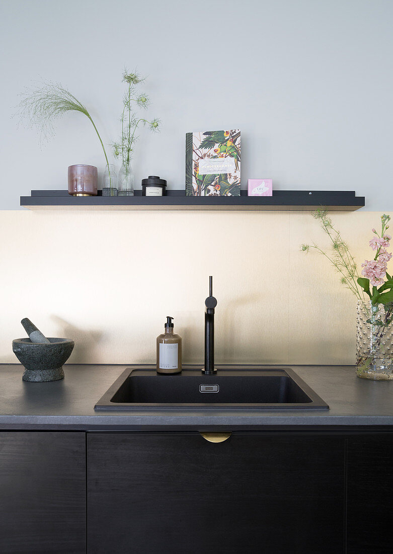 A dark kitchenette with a sink