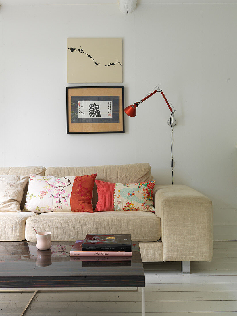 Asian cushions on a beige sofa in a living room