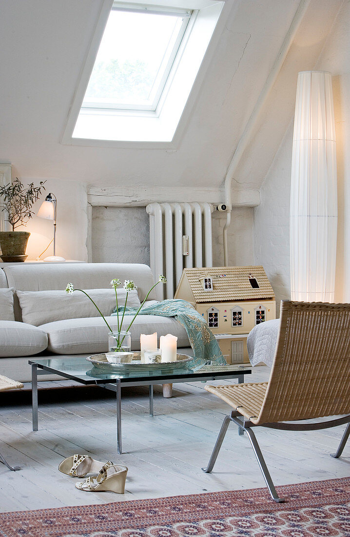 Light, feminine living room under the slope with skylight