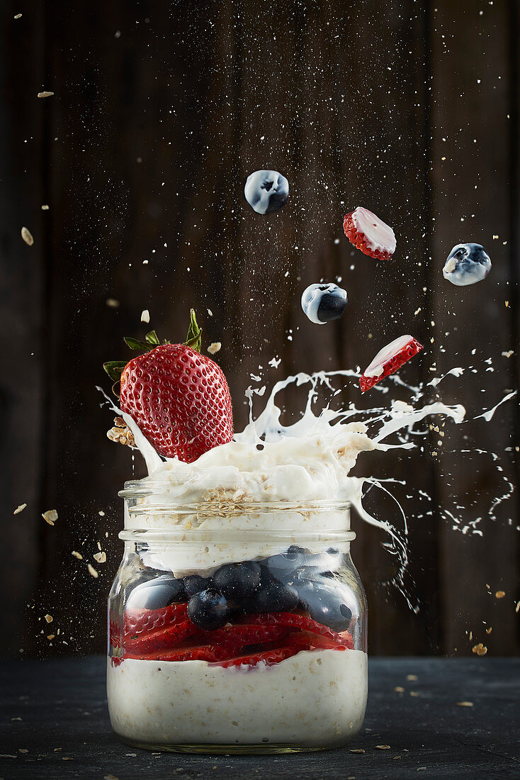 Muesli with yoghurt splash and berries in glass