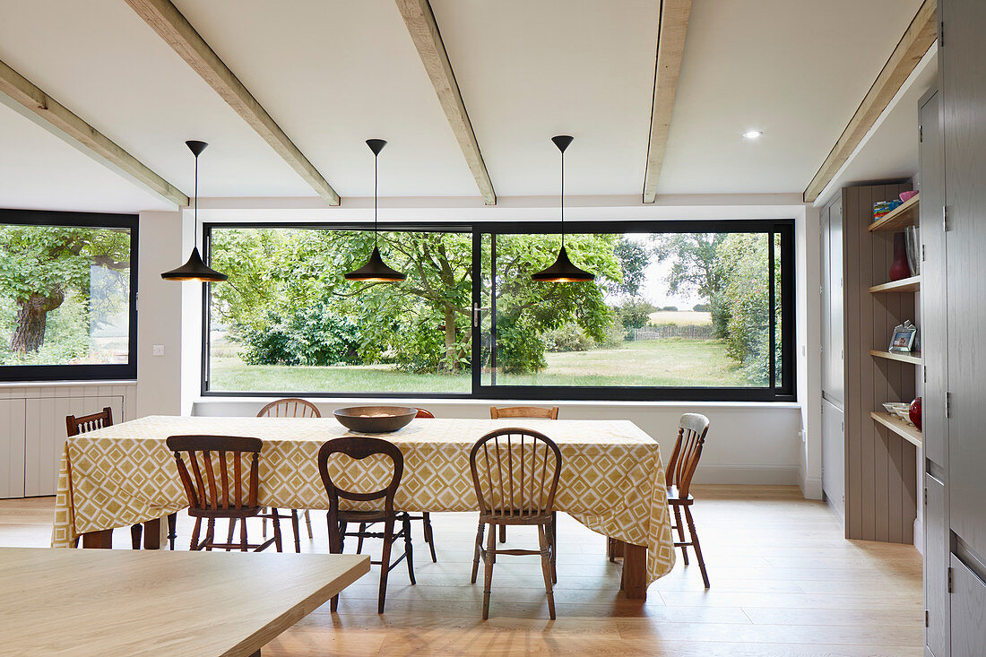 Open plan dining room with large windows looking out onto the garden