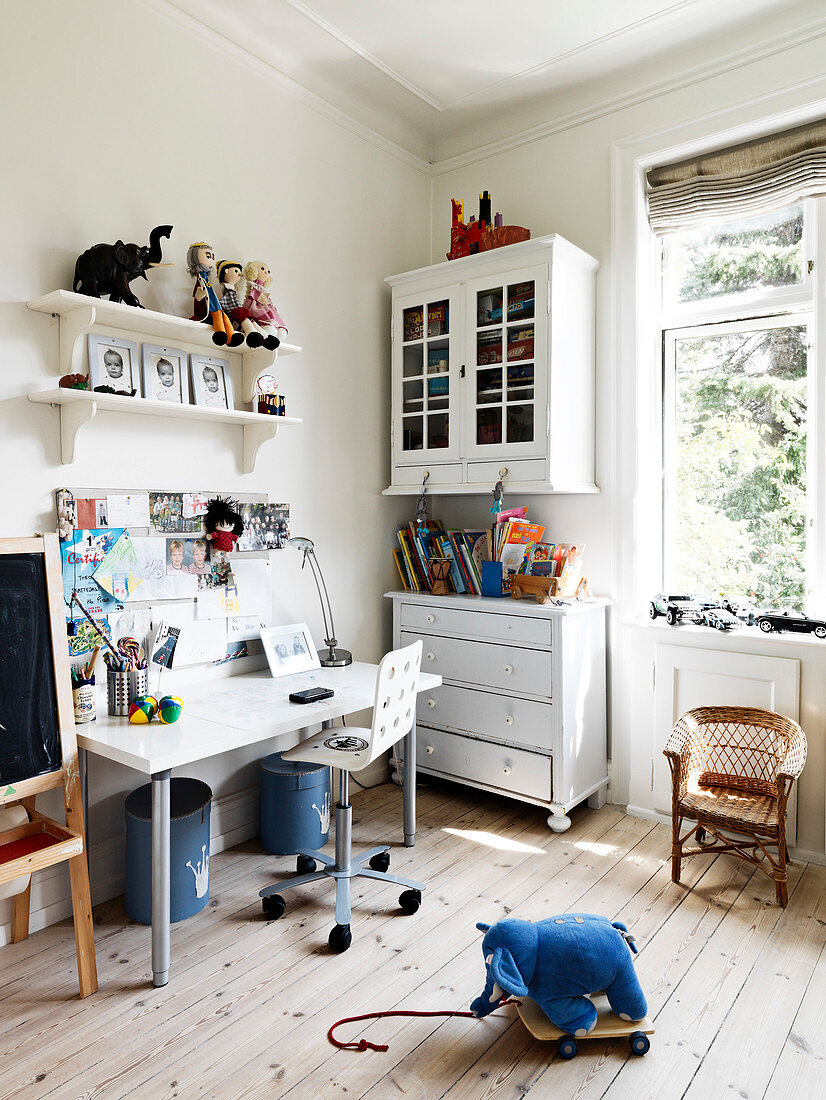 Desk in children's room with nostalgic furniture and plank floor
