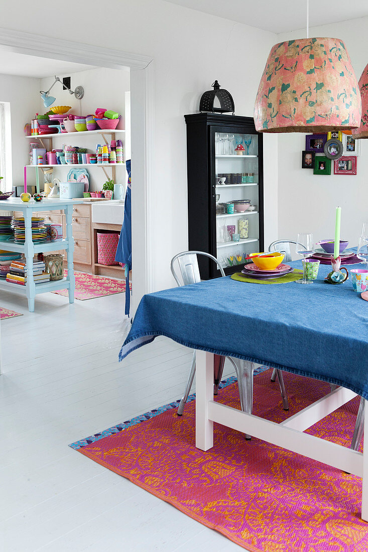 A table laid for Asian food with a pendant lamp with a retro lampshade above it