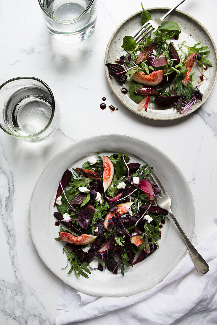 An autumnal mixed leaf salad with beetroot, figs, purple carrots and feta cheese