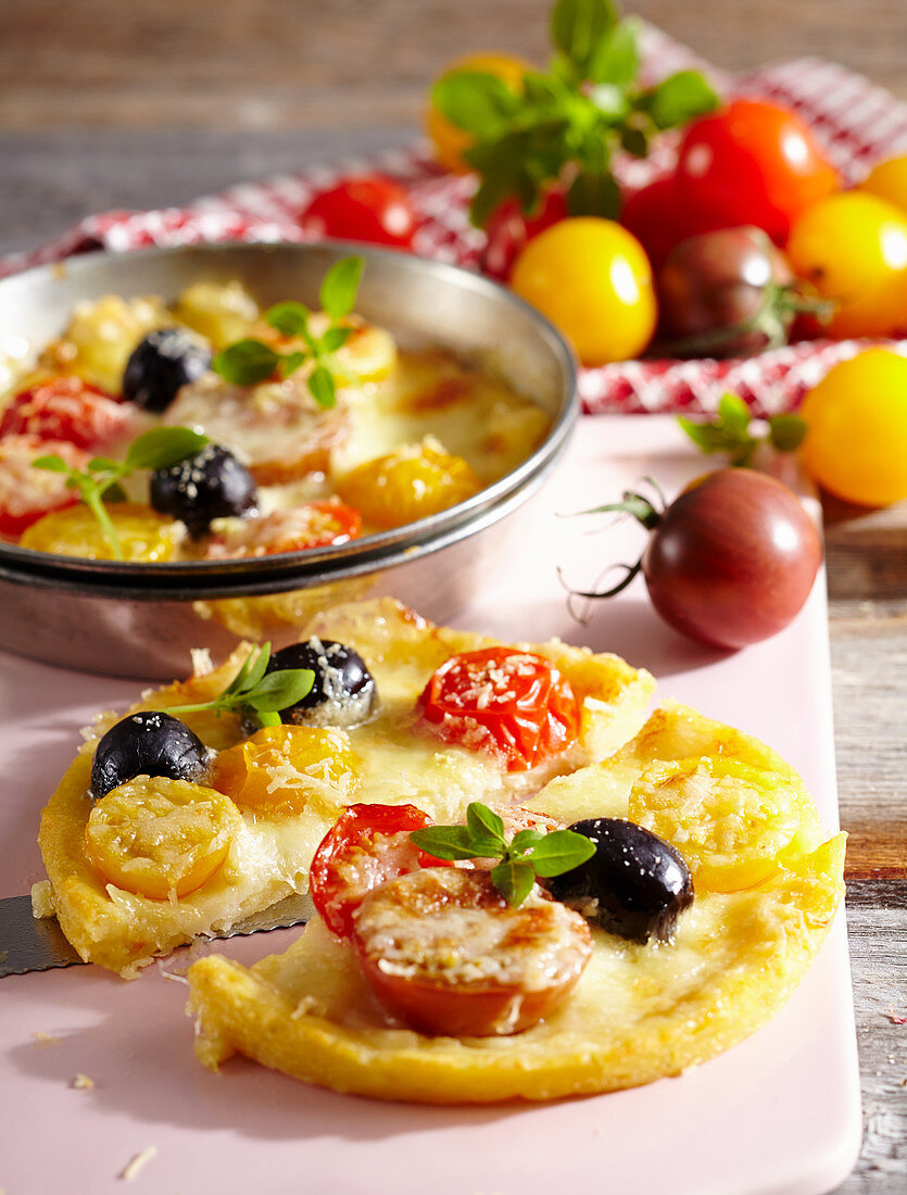 Mini potato pies with cherry tomatoes and olives