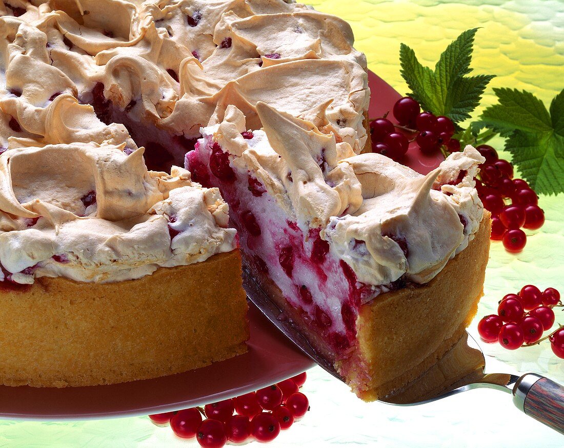 Redcurrant meringue tart, a piece cut