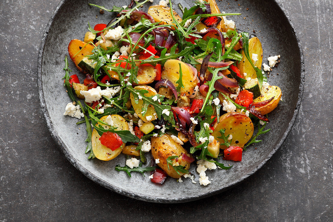 Roast potato salad with peppers, courgette and feta cheese