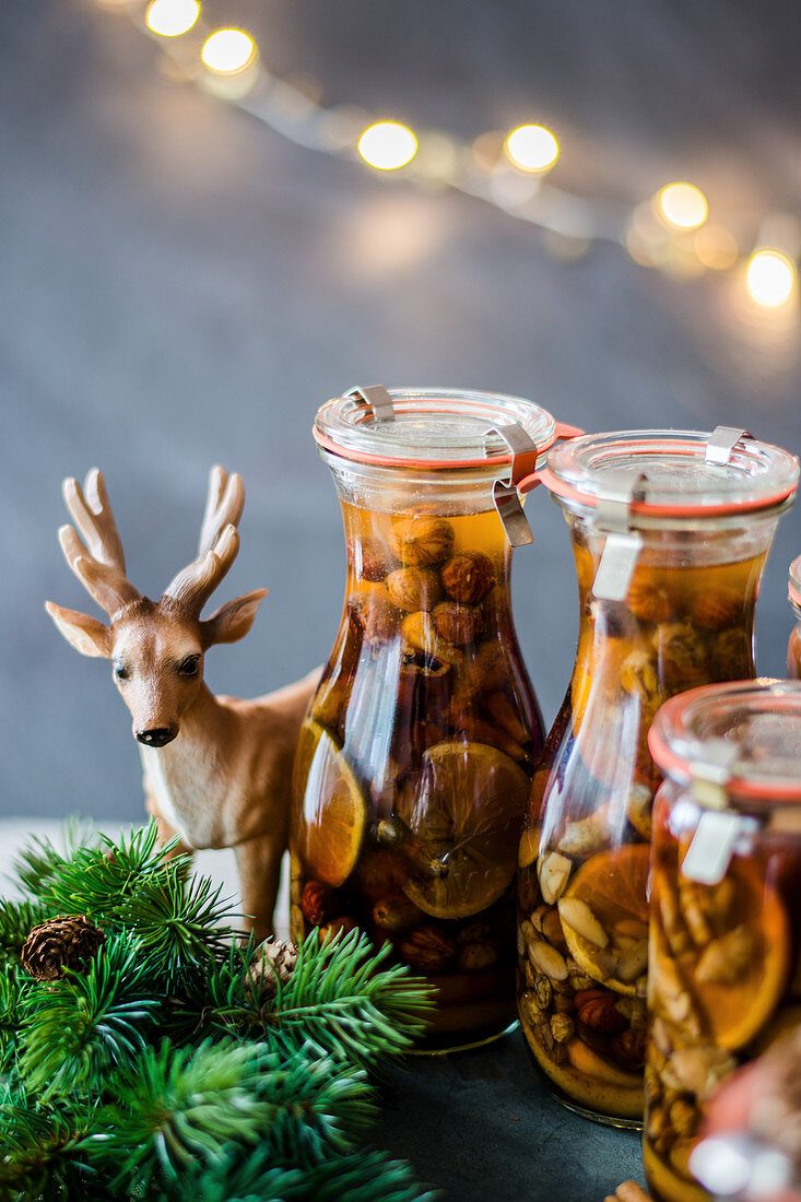 Homemade Christmas liqueur with dried fruits, citrus and nuts