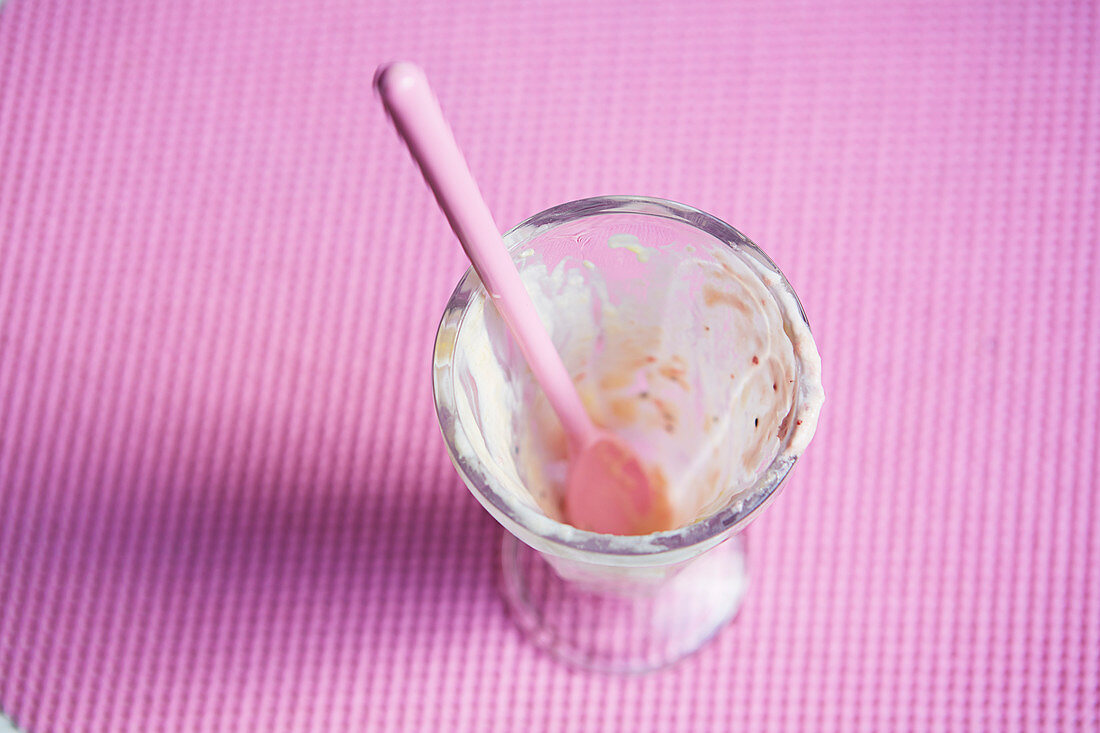 Empty cup of ice cream on a pink background