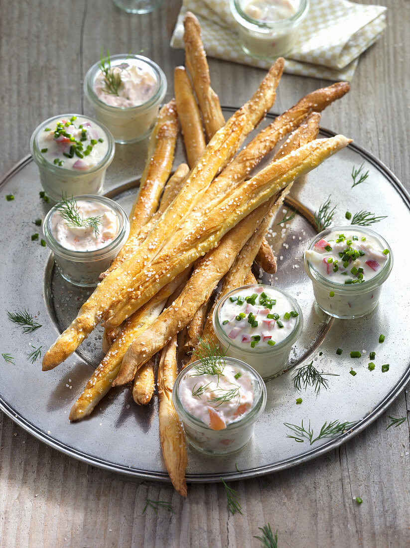 Homemade pretzel sticks with egg, bacon and salmon dips