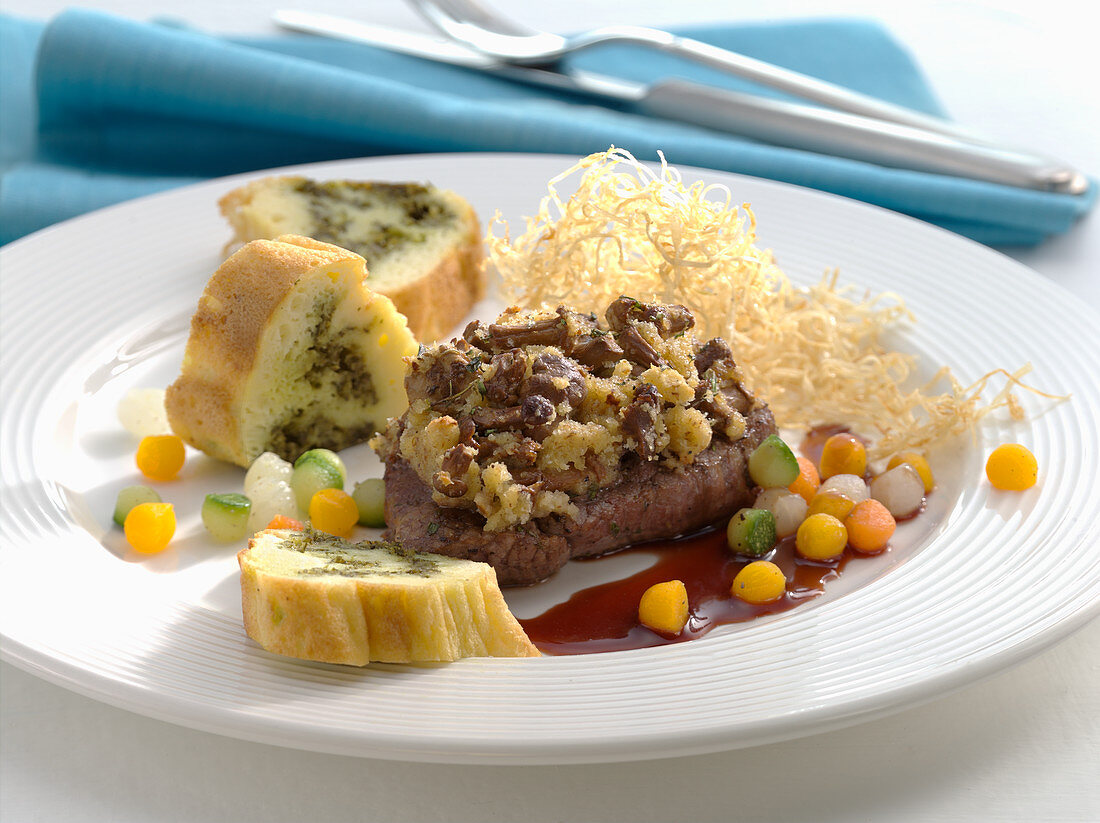 Ostrich fillet with chanterelle crust, celery straw, and potato pesto roulade