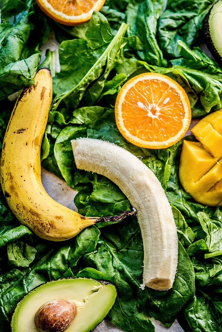 Bananas, oranges, mango, avocados and spinach for a smoothie