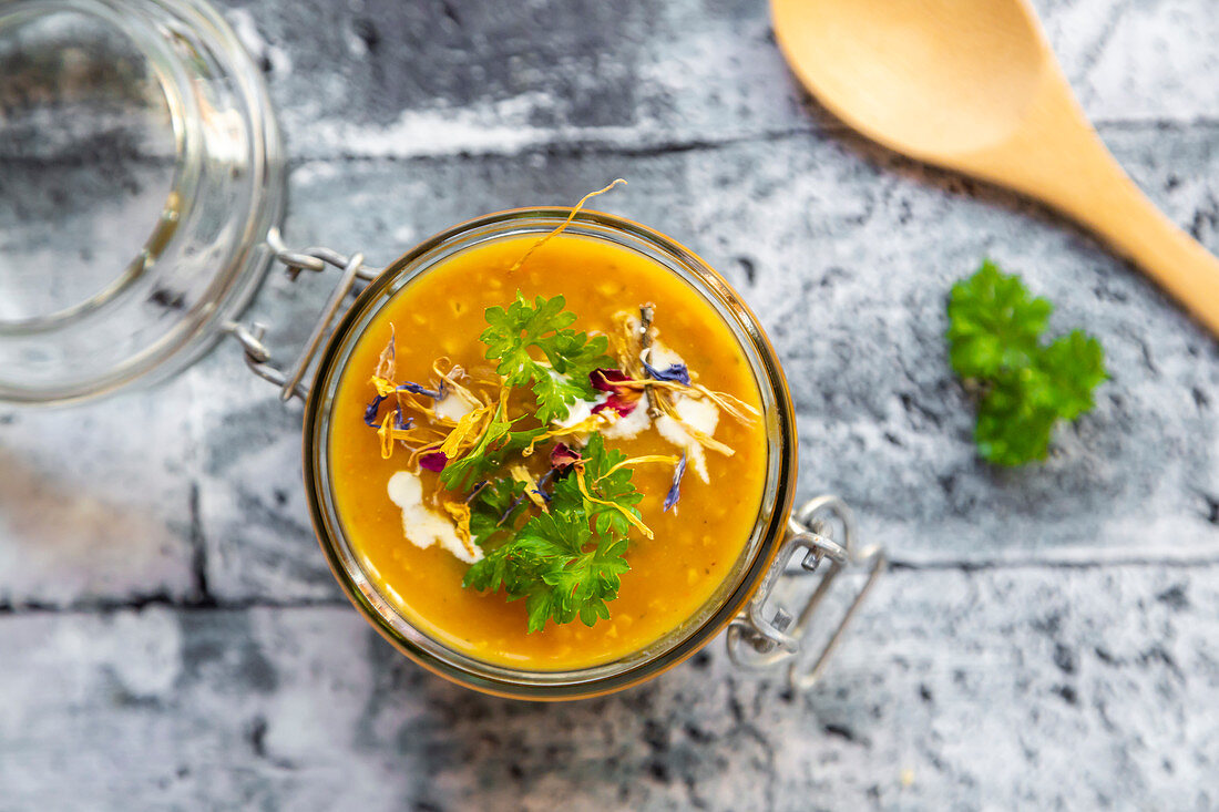 Pumpkin soup with lupine meal (minced meat substitute), parsley and dried edible flowers