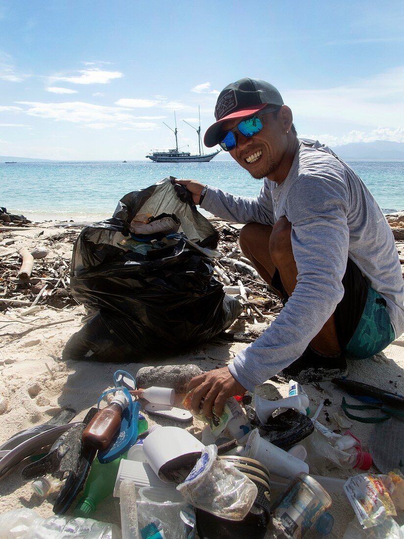 Collecting plastic waste on a beach,Indonesia