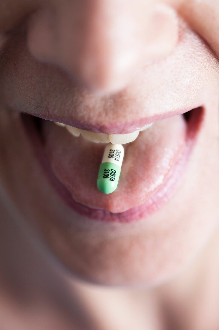 Close-up of Prozac antidepressant pill on woman's tongue