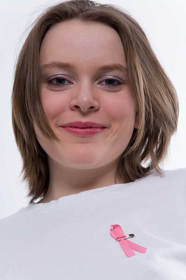 Portrait of a teenage girl wearing an awareness pink ribbon