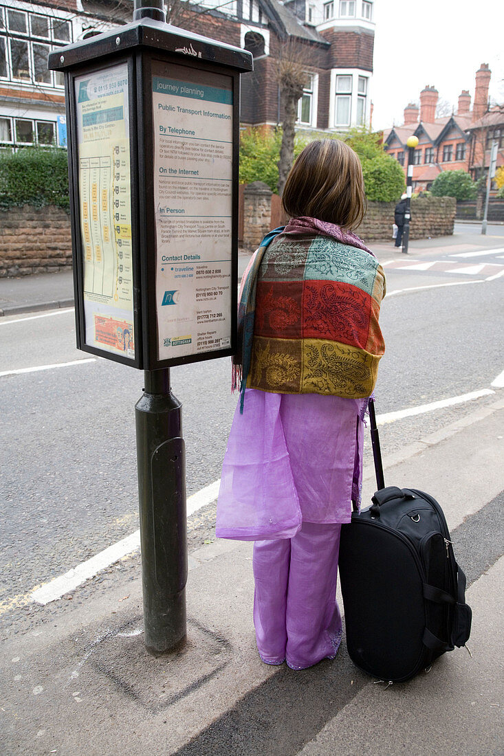 Woman waiting for bus at the bus stop