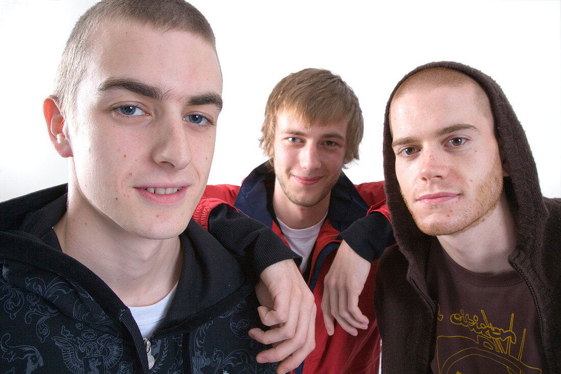 Studio portrait of three young men smiling