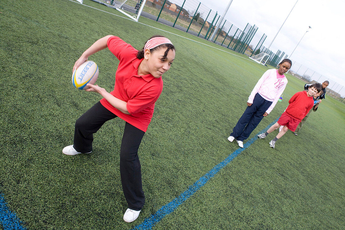 Group of children practicing rugby