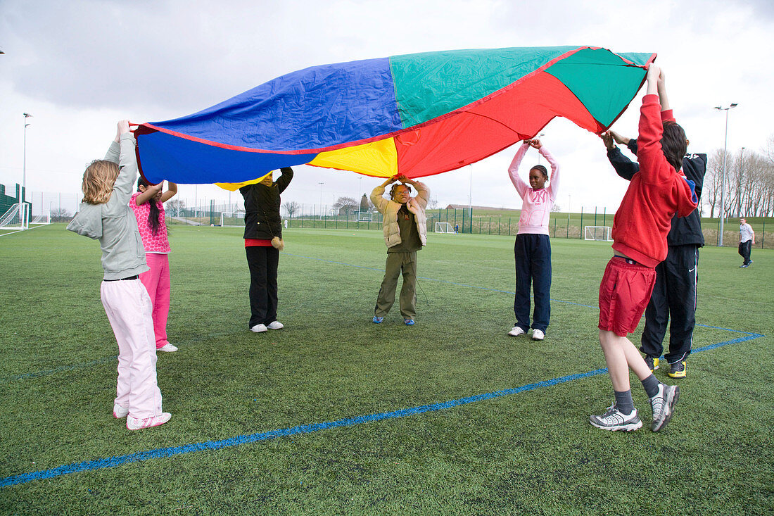 Group of children playing the parachute game